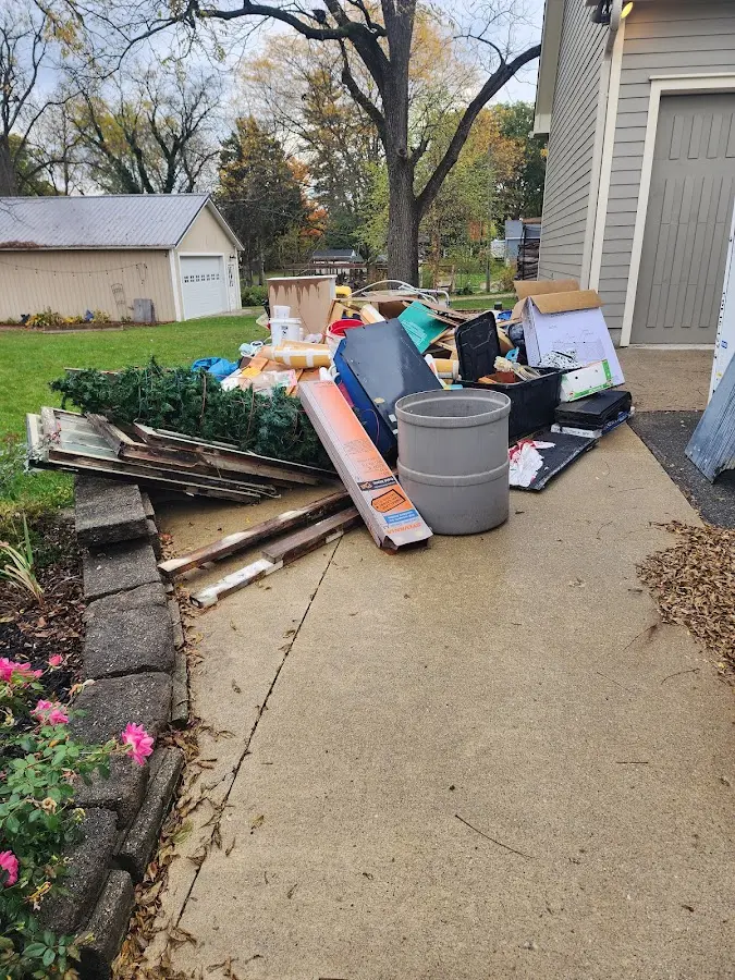 Dumpster being loaded with debris for Demolition Dumpster Rental in Huntington